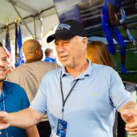 Guests pointing at other guests at the Jamie Hosford Football Center dedication.